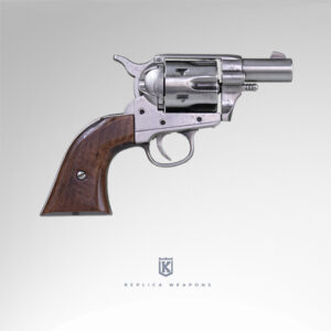 Vista lateral derecho de réplica de revolver Colt Pocket USA 1873 Calibre 45. Con cañón, tambor y cuerpo en metal pulido con cachas en madera.