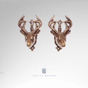 Réplica de soportes de pistola con forma de cabezas de ciervos. Terminado en color dorado latonado envejecido.